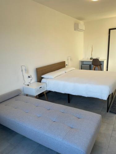 a bedroom with two beds and a couch in it at Agriturismo Al Mancino in Lonato del Garda