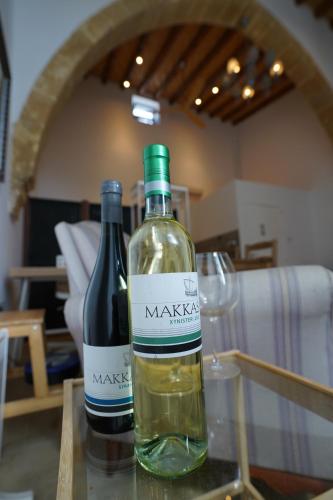 two bottles of wine sitting on a table with a glass at Large Kamara Studio in Nicosia