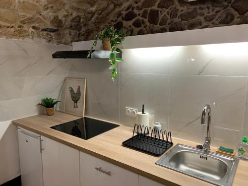 a kitchen with a sink and a counter with a sink at Studio Perle de Menton in Menton