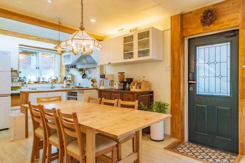 a kitchen with a wooden table and chairs at I'm Green Stay in Seoul