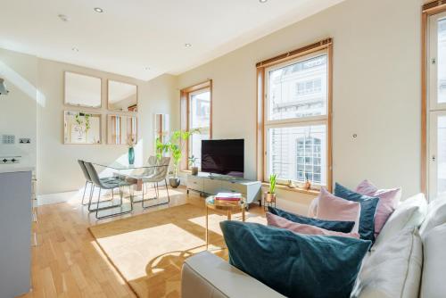a living room with a couch and a tv at Welcome London Piccadilly Circus in London