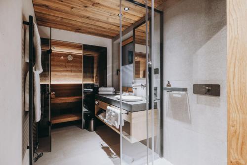 a bathroom with a sink and a mirror at Balma Restaurant Apart in Lech am Arlberg