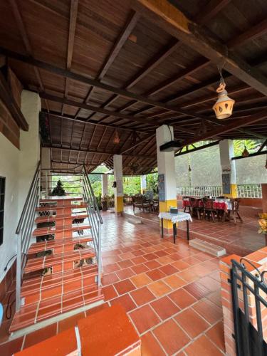 a building with a staircase and tables and chairs at El Mortiño in San Gil