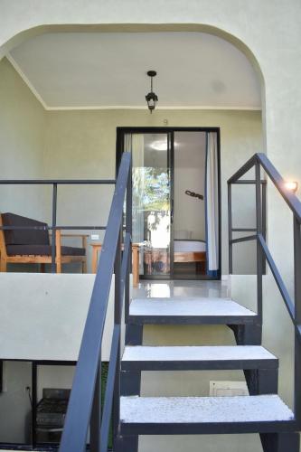 a set of stairs leading to a house at Fuego Lodge in Santa Teresa Beach