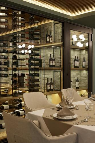 a dining room with a table and chairs and wine racks at Origen 438 Luxury Boutique Hotel in Guadalajara