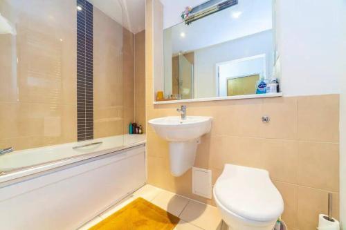 La salle de bains est pourvue d'un lavabo, de toilettes et d'une baignoire. dans l'établissement Charming 2 Bed flat near Greenwich, à Londres