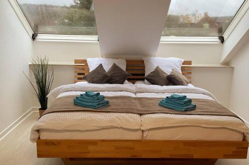 a bedroom with a bed with two towels on it at Appartement im Bielefelder Westen in Bielefeld