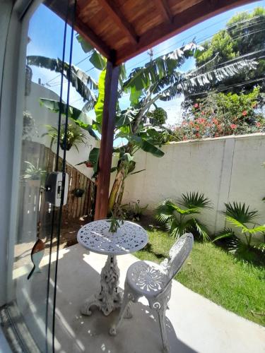 a table and two chairs and a table and a table and chairs at Estrela Azul Guest House Búzios in Búzios