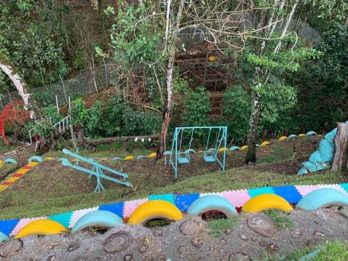 a play yard with a playground with a play set at Parcelacion Bosque de Hadas in Popayan