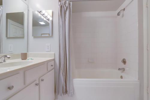 a white bathroom with a shower and a sink at Apartment with Panoramic City view of Ballston in Arlington