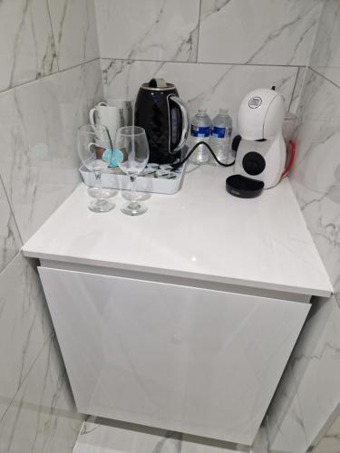 a white counter with glasses and a coffee maker on it at Unit 8 Adult Lovers Hotel in Handsworth