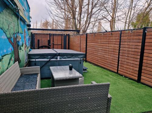 a backyard with two chairs and a table and a fence at Unit 8 Adult Lovers Hotel in Handsworth