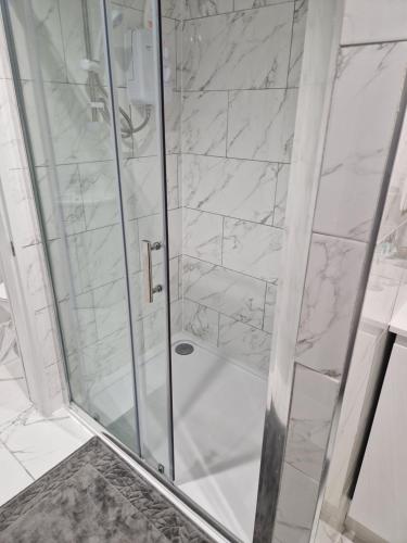 a bathroom with a shower with white marble at Unit 8 Adult Lovers Hotel in Handsworth