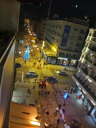 a view of a city street at night with a christmas tree at Adriana's Apartment in Skopje