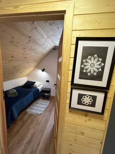 a bedroom with a bed in a small room at Cichata - domek w Bieszczadach in Czarna