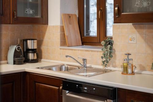 a kitchen with a sink and a counter top at Parnassus Woodstone Chalet in Áno Polídhrosos