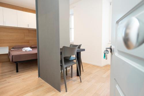 a room with a table and a bed in a room at Hurban Apartments Venezian in Trieste