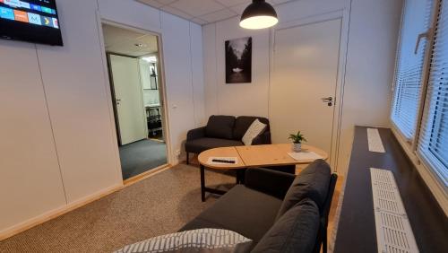 a living room with a couch and a table at Aparthotel Clock 2 in Kotka