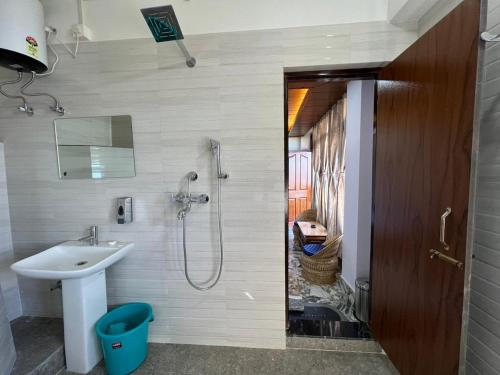 a bathroom with a sink and a shower at Morning Mist Homestay in Gangtok