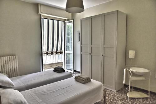 a bedroom with two beds and a window at Casavimo in Vimodrone