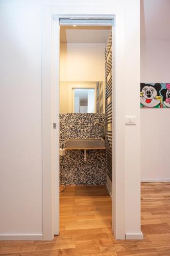 a door leading into a room with a mirror at Hurban Apartments Venezian in Trieste