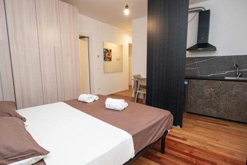 a bedroom with a bed with two towels on it at Hurban Apartments Venezian in Trieste