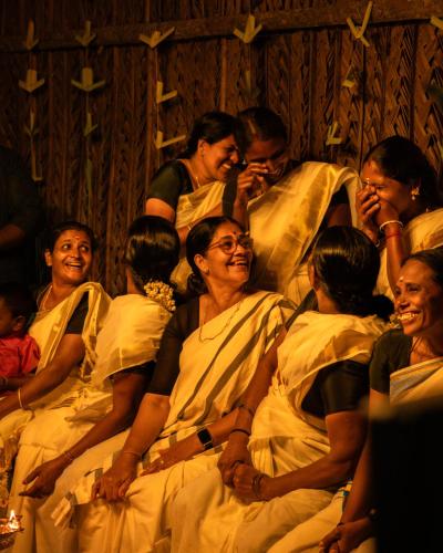 a group of people in white robes sitting together at The Mudhouse Marayoor in Munnar