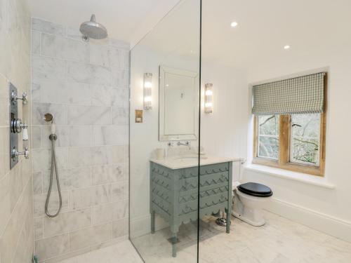 a bathroom with a shower and a sink and a toilet at Wood Stanway House in Cheltenham