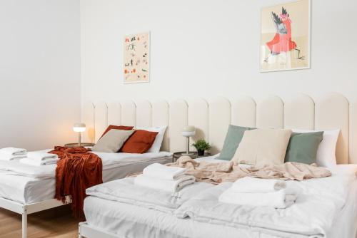 uma sala de estar com duas camas e cobertores em Modern Centrally Located Apartment na Cracóvia