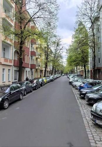 a street with cars parked on the side of the road at Erstklassiges Studio im Zentrum in Berlin