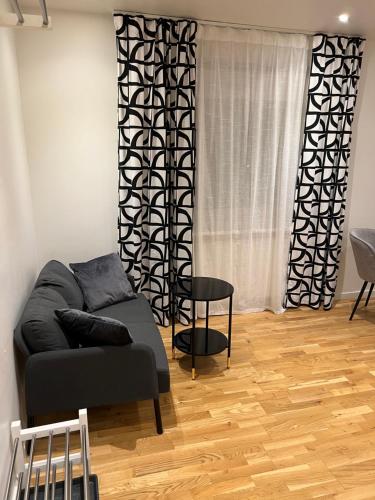 a living room with a couch and a chair at Noah Longstay Apartment in Västerås