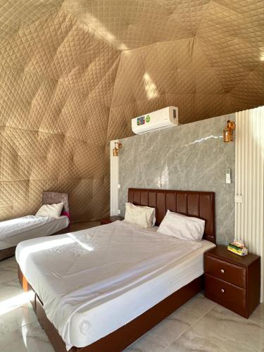 a bedroom with a large bed with at Rum Mars camp in Wadi Rum