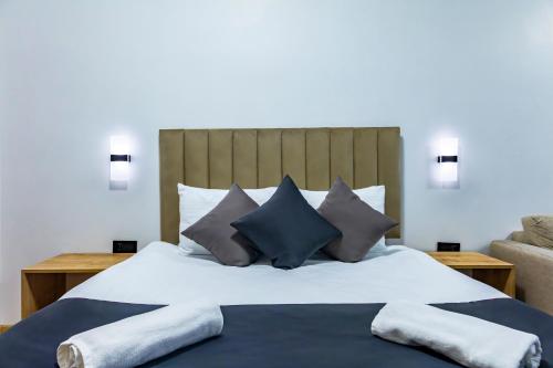 a bedroom with a large bed with blue and grey pillows at Mia Mia Suites in Istanbul