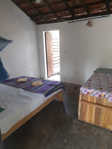 a bedroom with a bed and a window in it at School Keen Kite Surf in Kalpitiya