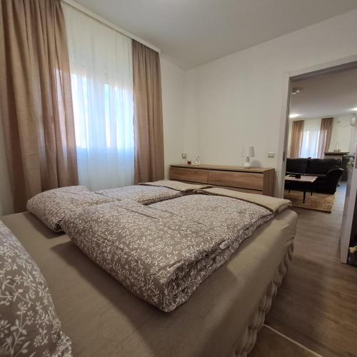 a bedroom with a large bed and a mirror at APARTMAN011 in Mirijevo