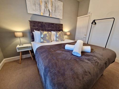 a bedroom with a large bed with two pillows at Cosy Luxury Home next to City Centre with Free Parking - Contractors & Relocators in Coventry