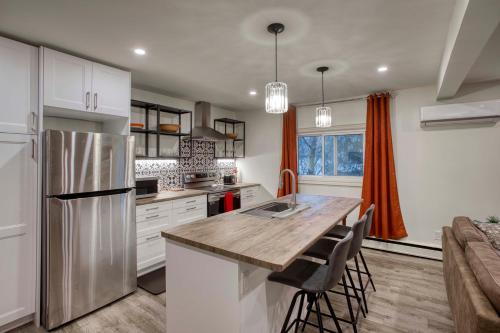 a kitchen with white cabinets and a wooden counter top at Comfort Home Stays in Lincoln Niagara in Beamsville