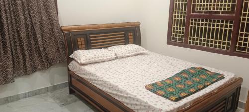 a bed with two pillows on it in a bedroom at Srinivas service home in Rājahmundry