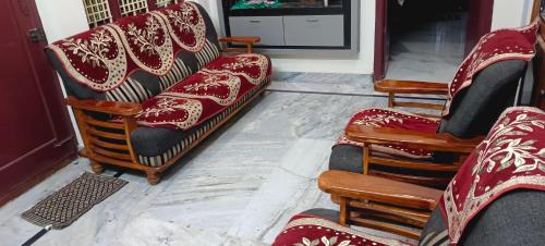 a group of chairs and a couch in a room at Srinivas service home in Rājahmundry