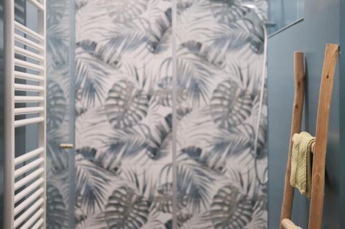 a shower curtain with a blue and white pattern at La Cles Deluxe Suites in Cles