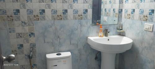 a bathroom with a sink and a toilet at Executive home Stay Sector75 Noida in Noida