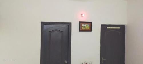 two black doors are on a white wall at Executive home Stay Sector75 Noida in Noida