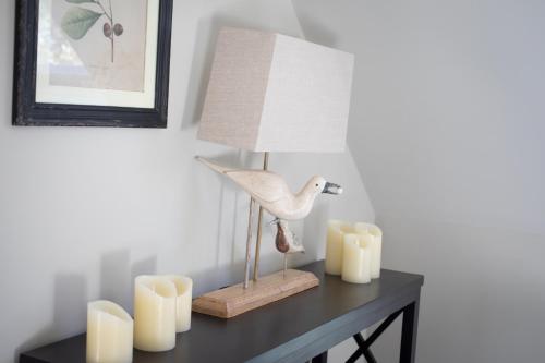 a lamp on top of a table with candles at Lakeview Barn, sleeps 5-7 Guests new inside in Matlock