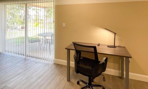 an empty office with a desk and a chair at Summerwind Studios in Fort Myers