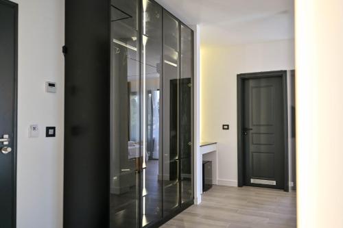 a hallway with glass walls and a door at Botanica Boutique Hotel in Ulcinj