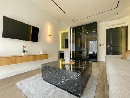 a living room with a black marble coffee table at Botanica Boutique Hotel in Ulcinj