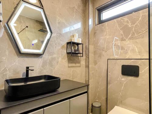 a bathroom with a black sink and a mirror at Botanica Boutique Hotel in Ulcinj