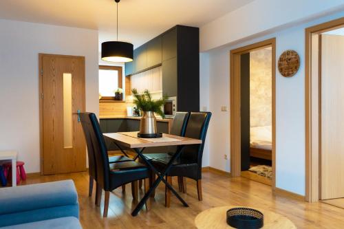 a dining room and kitchen with a table and chairs at Apartmány Bobrík in Liptovský Mikuláš