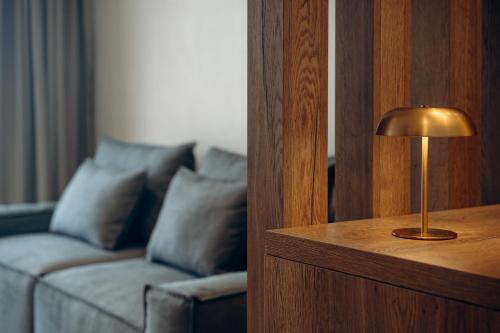 a lamp on a table next to a couch at ACRON 12 penthouse Acropolis suites in Athens