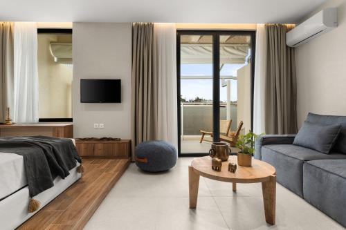 a bedroom with a bed and a couch and a table at ACRON 12 penthouse Acropolis suites in Athens